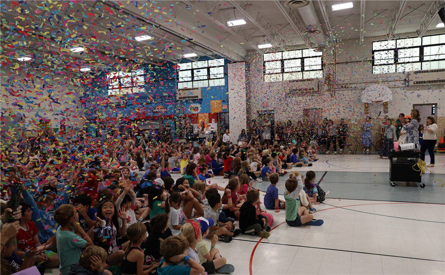  Confetti falls from the ceiling at an assembly for Long Elementary students
